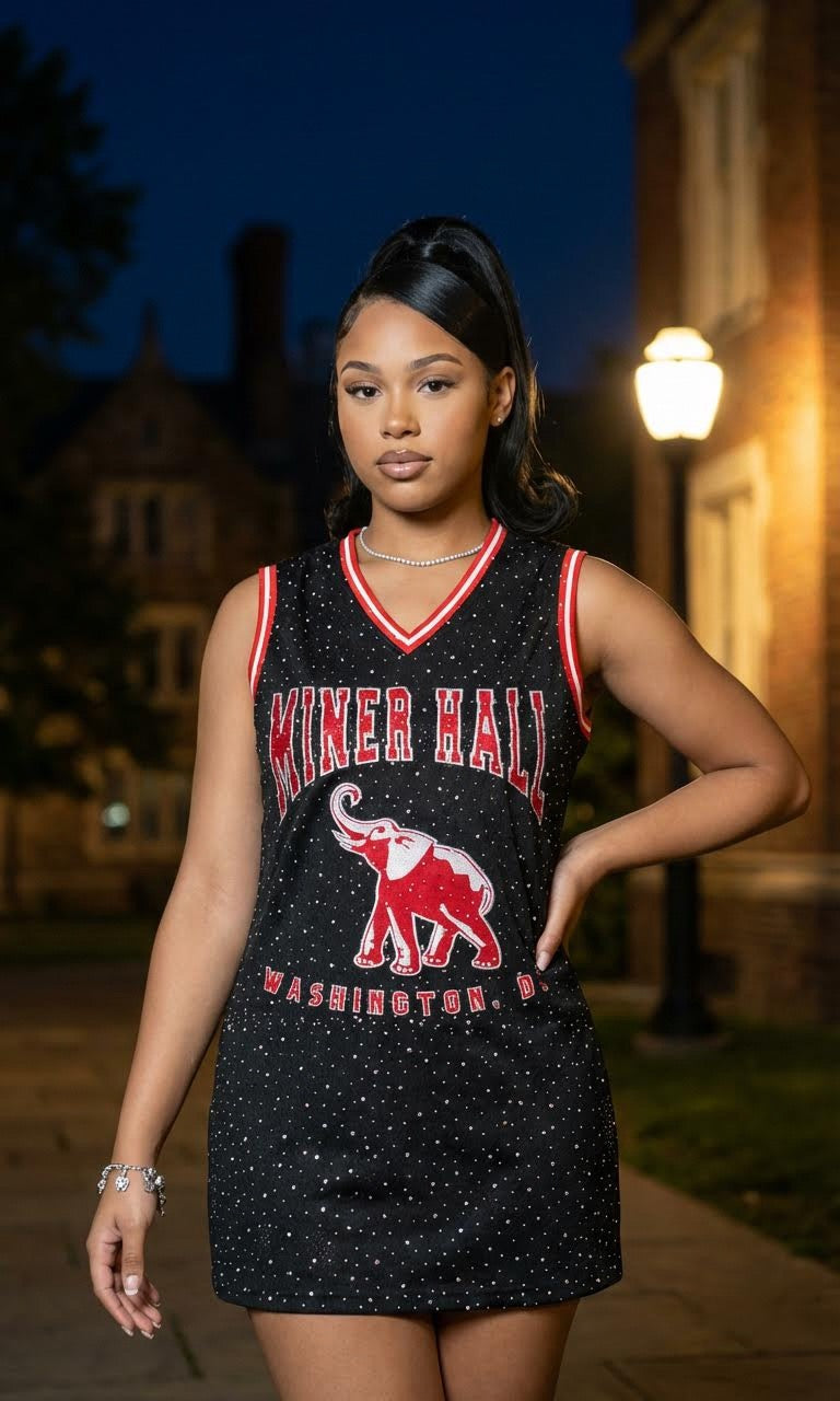 Woman wearing a black and red 'Miner Hall' dress with an elephant graphic at night.